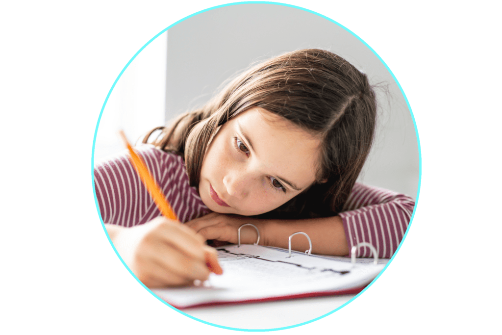 Child doing homework on with pencil and paper